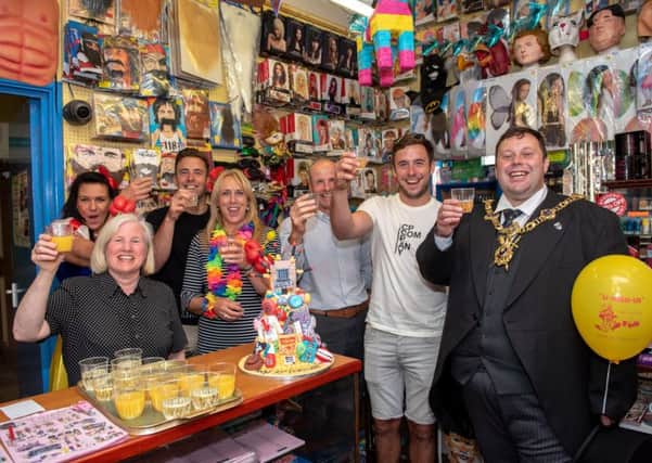 The Lord Mayor of Portsmouth, Cllr Lee Mason, and the owners and staff of the shop raise their glasses to celebrate 95 years of U-Need-Us  
Picture: Vernon Nash (180396-006)