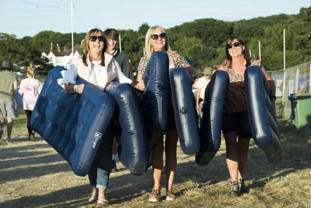 Heather Dockerty, April Beggs and Lorraine McAlister from Northern Ireland carry airbeds on site at the Isle of Wight festival at Seaclose Park, Newport. Photo: David Jensen/PA Wire SHOWBIZ_Festival_065368.JPG