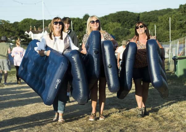 Heather Dockerty, April Beggs and Lorraine McAlister from Northern Ireland carry airbeds on site at the Isle of Wight festival at Seaclose Park, Newport. Photo: David Jensen/PA Wire SHOWBIZ_Festival_065368.JPG