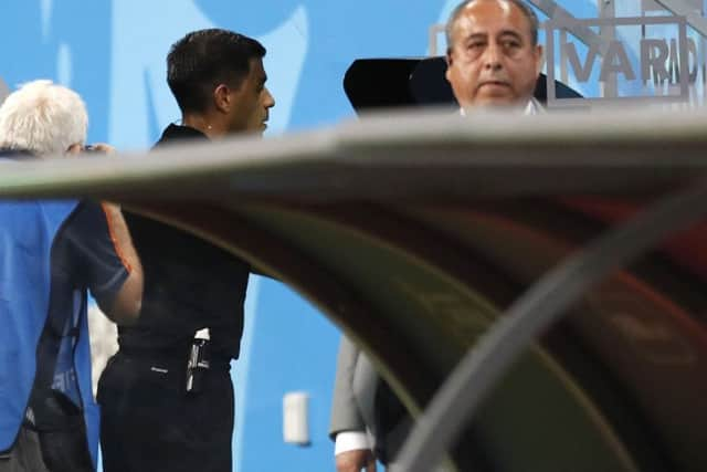 Referee Enrique Caceres watches the VAR during the Group B match between Iran and Portugal Picture (AP Photo/Pavel Golovkin)