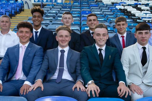 Eight new Pompey scholars pen two-year deals at Fratton Park. Back row: Academy chief Mark Kelly, Haji Mnoga, Alfie Stanley, Harry Kavanagh, Stan Bridgman and coach Liam Daish. Front row: Tom Bruce, Ethan Robb, Liam Kelly and Leon Pitman. Picture: Simon Hill/Portsmouth FC