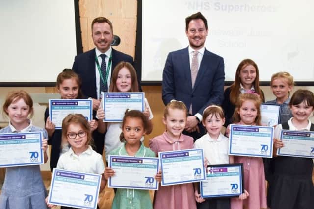 School children wrote and performed songs on the NHS celebrating its 70th anniversary this year. Pictured are the winners of the competition with QA Hospital chief executive Mark Cubbon and Portsmouth South MP Stephen Morgan. Picture: QA Hospital