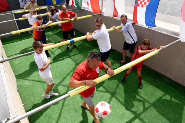 People playing on the life sized table football pitch built by Iain-Paul Hutton in his garden for the World Cup Picture: Tom Harrison/Solent News & Photo Agency