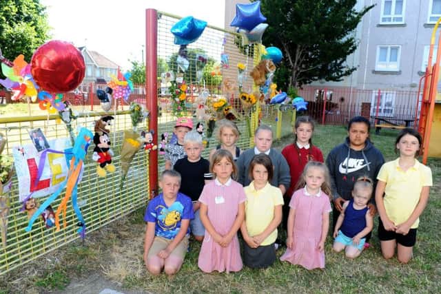 Leo's friends with tributes at a play park