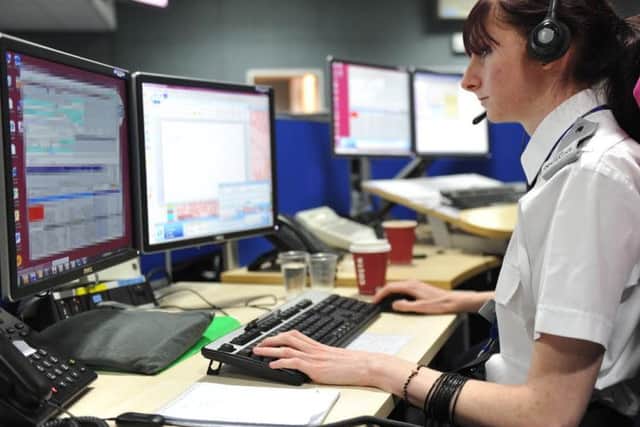 A stock photo of a call handler in Northamptonshire Police's Force Control Room
