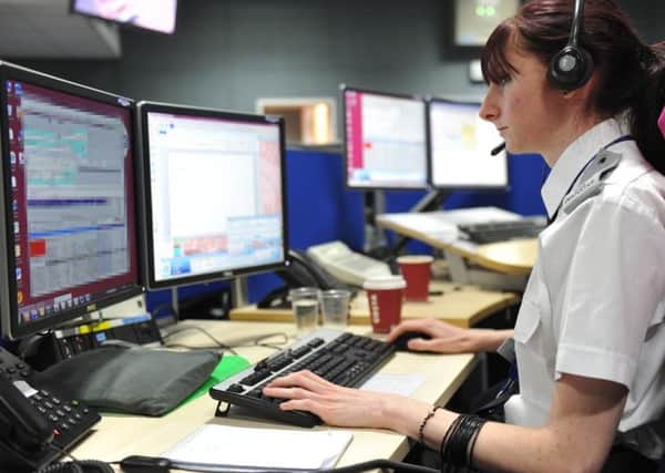 A stock photo of a call handler in Northamptonshire Police's Force Control Room