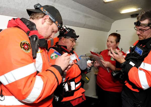 Nathan Allen, search technician, Terry Huppler, team leader, Michelle Bavin, training officer and Stephen Bavin, team leader, during a briefing.

Picture: Sarah Standing