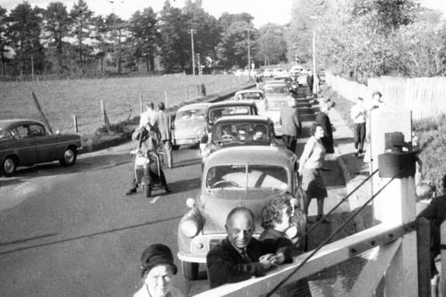 Afternoon delight at Langstone crossing. A pre-November 1963 view along Langstone Road with traffic queuing to cross the level crossing. Picture: Barry Cox Collection