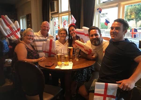 Fans watch England against Belgium in the Red Lion pub in Cosham
