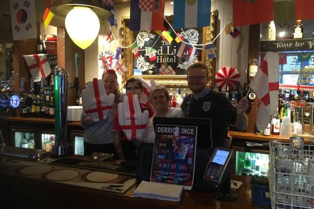 Fans and bar staff watch England against Belgium in the Red Lion pub in Cosham
