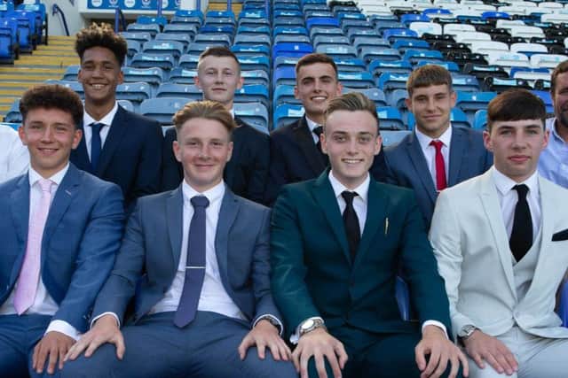 The eight new Pompey scholars with Mark Kelly, back left, and Liam Daish, back right. Picture: SImon Hill/ Portsmouth FC