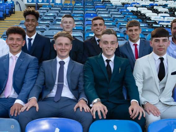The eight new Pompey scholars with Mark Kelly, back left, and Liam Daish, back right. Picture: SImon Hill/ Portsmouth FC