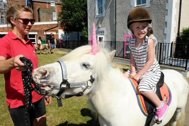 A unicorn visited Portsmouth High Prep School.Pictured is: Jessica Owen, 4, from Drayton with Nina Probert from Pony Magic.
Picture: Sarah Standing (180542-8375)