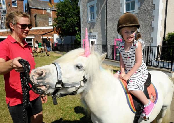 A unicorn visited Portsmouth High Prep School.

Pictured is: Jessica Owen, 4, from Drayton with Nina Probert from Pony Magic.


Picture: Sarah Standing (180542-8375)
