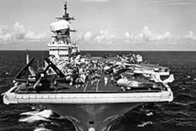 With her decks crowded with aircraft of all types HMS Victorious ploughs her way towards camera.