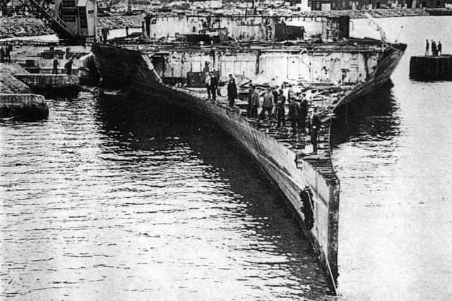 HMS Victorious at the Faslane breaker's yard and down to the waterline, a once a mighty aircraft carrier now only fit for razor blades.  Picture: Mike Nolan Collection