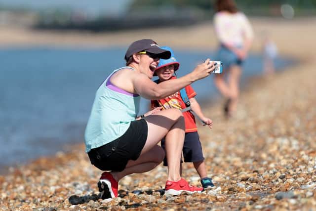 Nicola Pendleton and her son, Jacob, one, enjoying the hot weather on Sunday at Stokes Bay, Gosport Picture: Chris Moorhouse PPP-180306-162648006