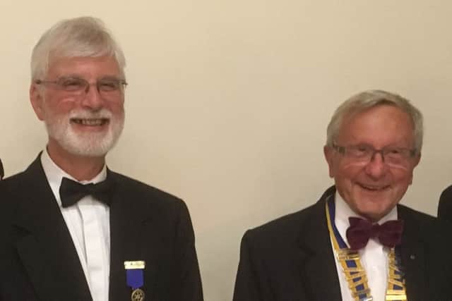 Bob Marshall, left, hands over the presidency of the Rotary Club of Fareham to Lyndon Palmer, right