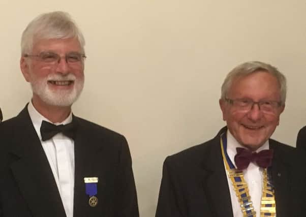 Bob Marshall, left, hands over the presidency of the Rotary Club of Fareham to Lyndon Palmer,  right
