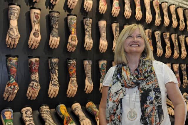 A new exhibition showing the history of tattooing has been opened at The Royal Navy Museum in Portsmouth. Jacqui Shaw of the RN Museum gives a final check that all is in place.
Picture: Ian Hargreaves  (180629-192327006)