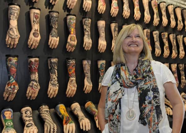 A new exhibition showing the history of tattooing has been opened at The Royal Navy Museum in Portsmouth. Jacqui Shaw of the RN Museum gives a final check that all is in place.

Picture: Ian Hargreaves  (180629-192327006)