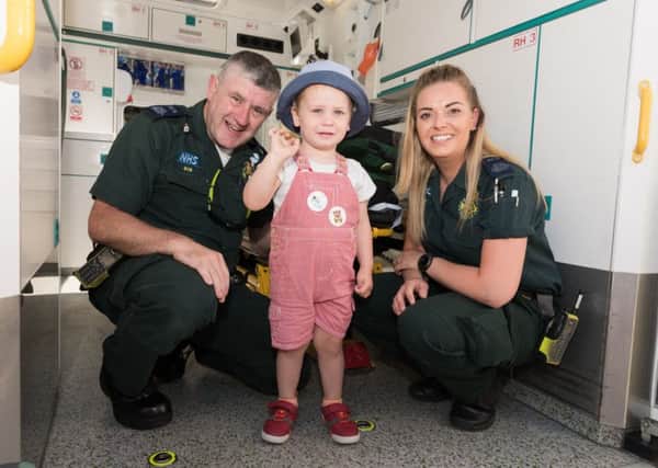 Emergency care assistants Bob Bell (Left) and Georgia Preston (right) of South Central Ambulance Service with Oliver Zaatar (2Yrs) 
Picture: Duncan Shepherd