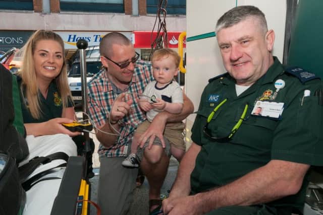 Emergency care assistants Georga Preston, left, and Bob Bell, right, of South Central Ambulance Service with Dave Thornbury and his son Harry, aged 15 months 
Picture: Duncan Shepherd