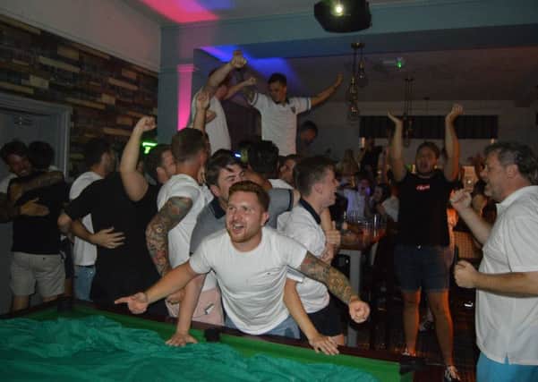 England fans celebrate Eric Dier's winning penalty in The Portsbridge, Cosham. Picture: David George