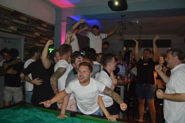 England fans celebrate Eric Dier's winning penalty in The Portsbridge, Cosham. Picture: David George