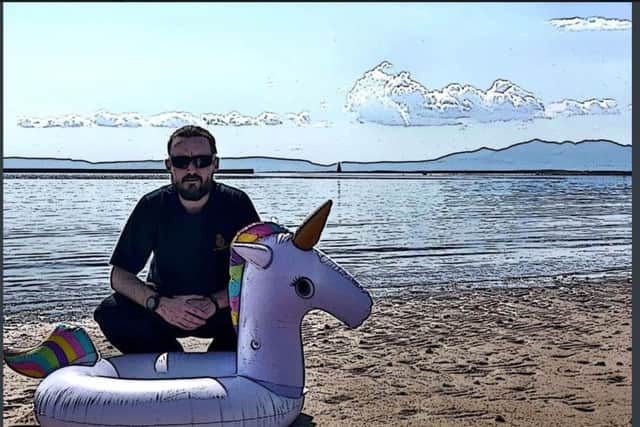 A member of the rescue teams with a recovered inflatable unicorn