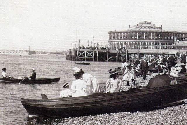 Dressed for summer. Gentlemen taking their girls dressed in white for a row alongside Clarence Pier, Southsea.