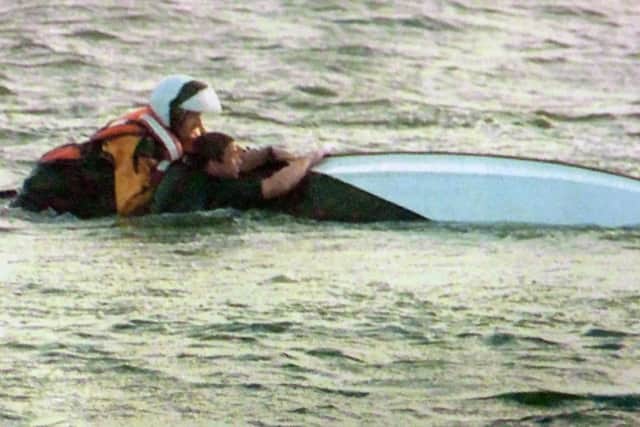 Mike Saunders, right, and lifeboatman Paul Lewis guide the dinghy to shore