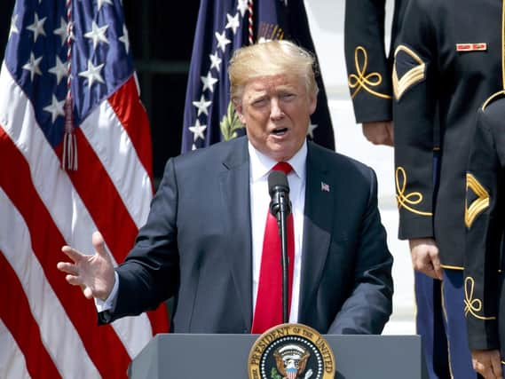 Protesters have been given permission to fly an 'angry Trump baby' balloon over London next week. Picture: AP Photo/ Evan Vucci