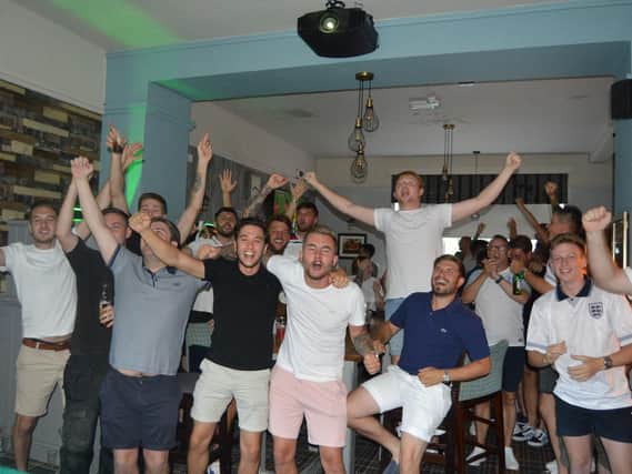 Fans celebrating at The Portsbridge after England's win against Colombia in the World Cup