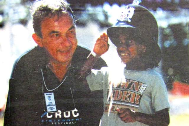 Sir John Hoddinott chats to an Aborigine boy during his visit to Australia