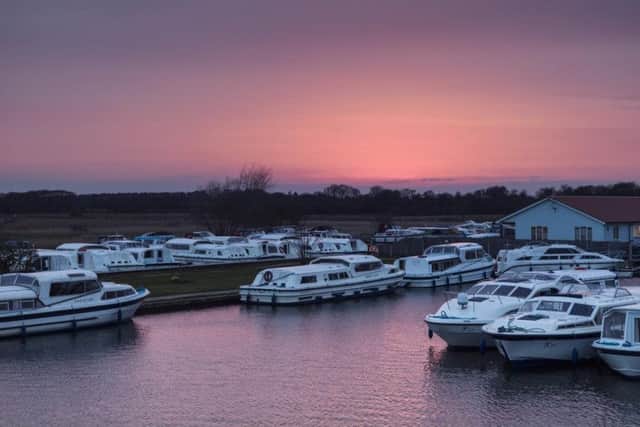 The sun sets over the Herbert Woods boatyard in Potter Heigham.