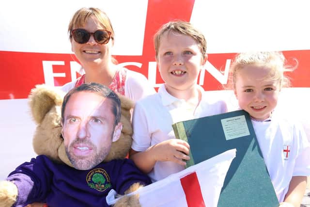 Pictured: Headteacher Mandy Grayson, Preston Prendiville, seven, and Phoebe Bushnell, six, with the 1976 register with Gareth's name inside