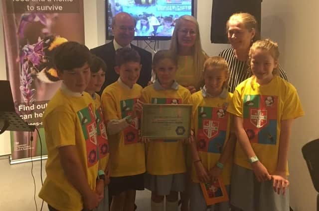 Pupils from St Alban's School in Havant, with their Pollinator Promise Award from Defra biosecurity minister, Lord Gardiner, back left. Credit: St Alban's School