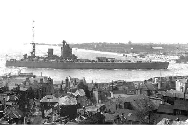 HMS Nelson entering Portsmouth Harbour before 1936. The tram gives us the date clue.