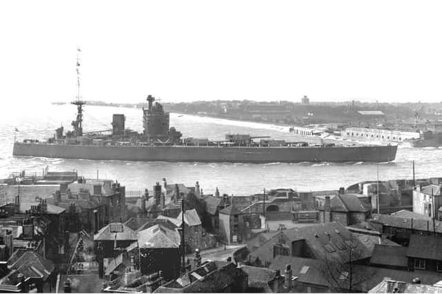HMS Nelson entering Portsmouth Harbour before 1936. The tram gives us the date clue.