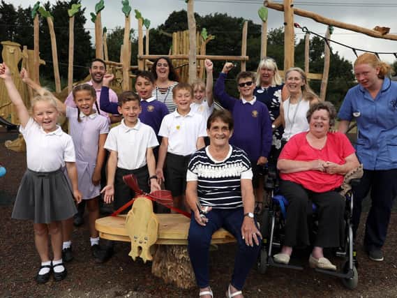 Wellington Vale care home residents Sandra Smith (in blue and white) and Eve Campion (in pink) and Berewood Primary School's school council at the unveiling of a bench in Newlands Walk play area that the residents helped to design. Picture: Chris Moorhouse