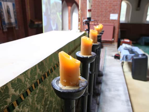 Candles were lit inside the church for Leo Burton's funeral. Picture: Habibur Rahman