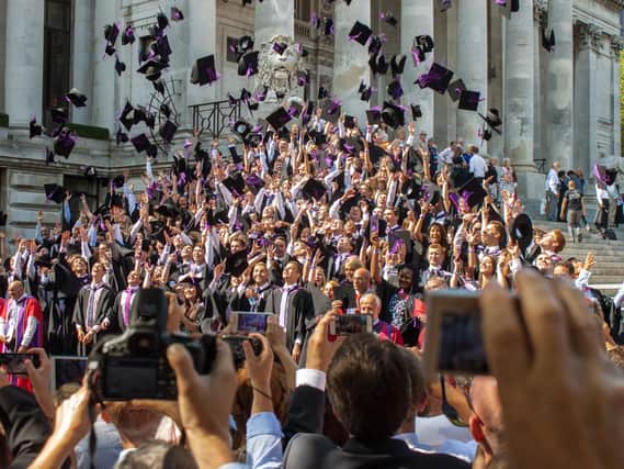 Graduates throw their mortar boards in the air during a University of Portsmouth graduation ceremony at The Guildhall, Portsmouth. 
Photo: Melanie Leininger.
