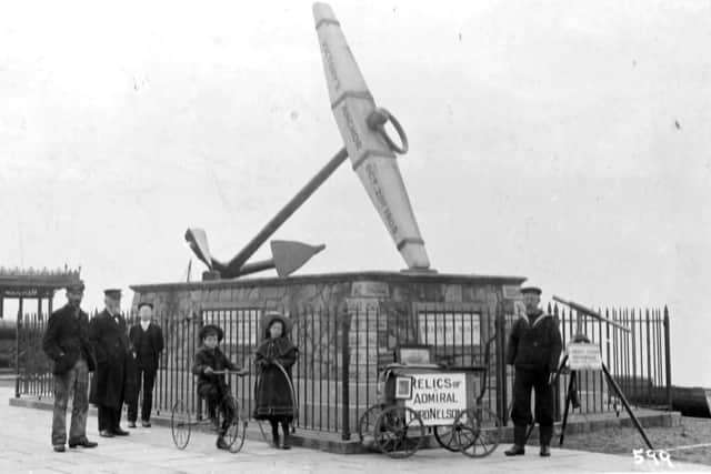A badly disabled sailor selling Nelson souvenirs on Southsea seafront, possibly in 1905.