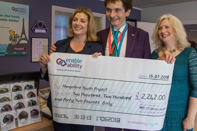 Harley Salter with Portsmouth North MP Penny Mordaunt, left, and his mother Vanessa, right - alongside his charity cheque