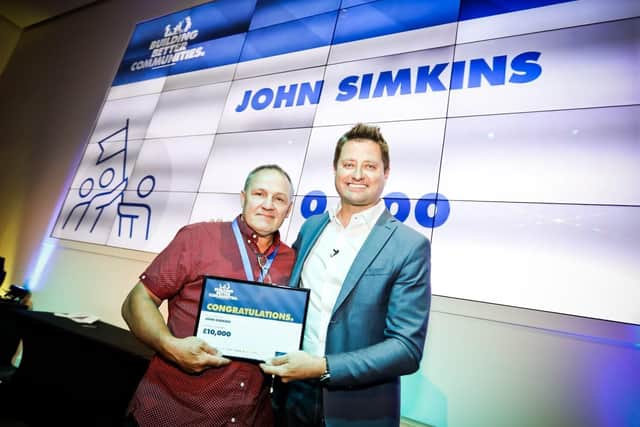 John Simkins, from Horndean, receiving his Trade Hero award from TV presenter George Clarke