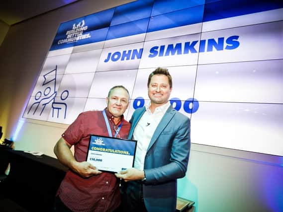 John Simkins, from Horndean, receiving his Trade Hero award from TV presenter George Clarke