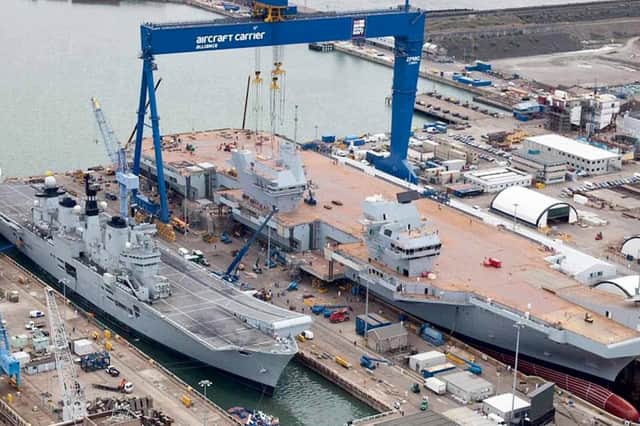 You might have thought the Invincible class carriers were big, but HMS illustrious is dwarfed alongside HMS Queen Elizabeth. Picture: Mike Nolan Collection.