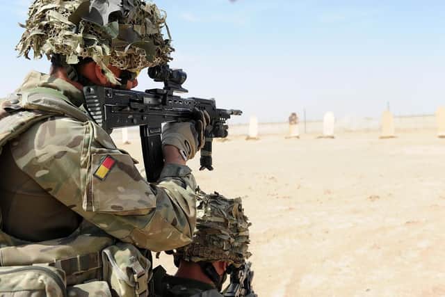 A soldier with A Company, 1 Royal Anglian is pictured firing his rifle