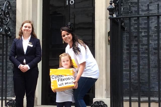 Gemma Weir and her four-year-old daughter Ivy, from Portsmouth, delivered hundreds of letters to Downing Street calling for drug Orkambi to be free. They are pictured with Grace Paget from the Cystic Fibrosis Trust